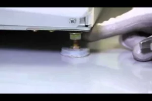 Adjusting the washing machine's leveling legs